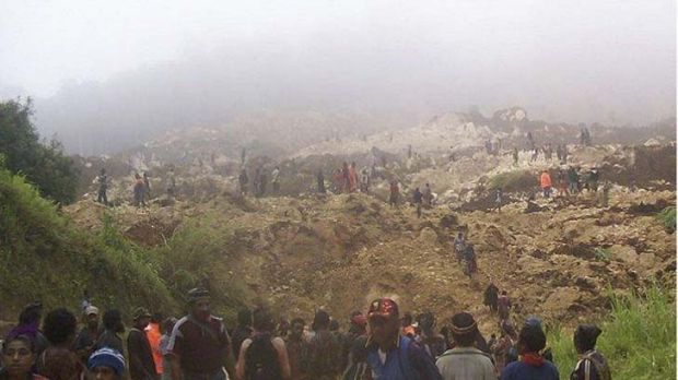 Destruction ... villagers search the site of the disaster, which is reported to have killed at least 40 people. Photo: AP